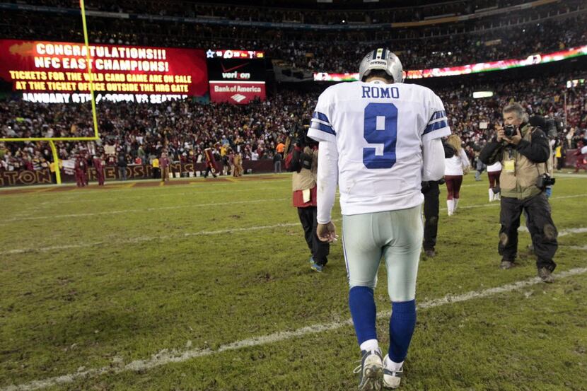 Cowboys quarterback Tony Romo walks off the field after Dallas' season-ending loss to...