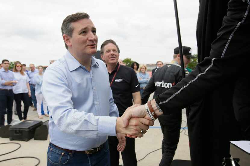 Sen. Ted Cruz, R-Texas, left, shakes hands with pit crew members before an afternoon session...