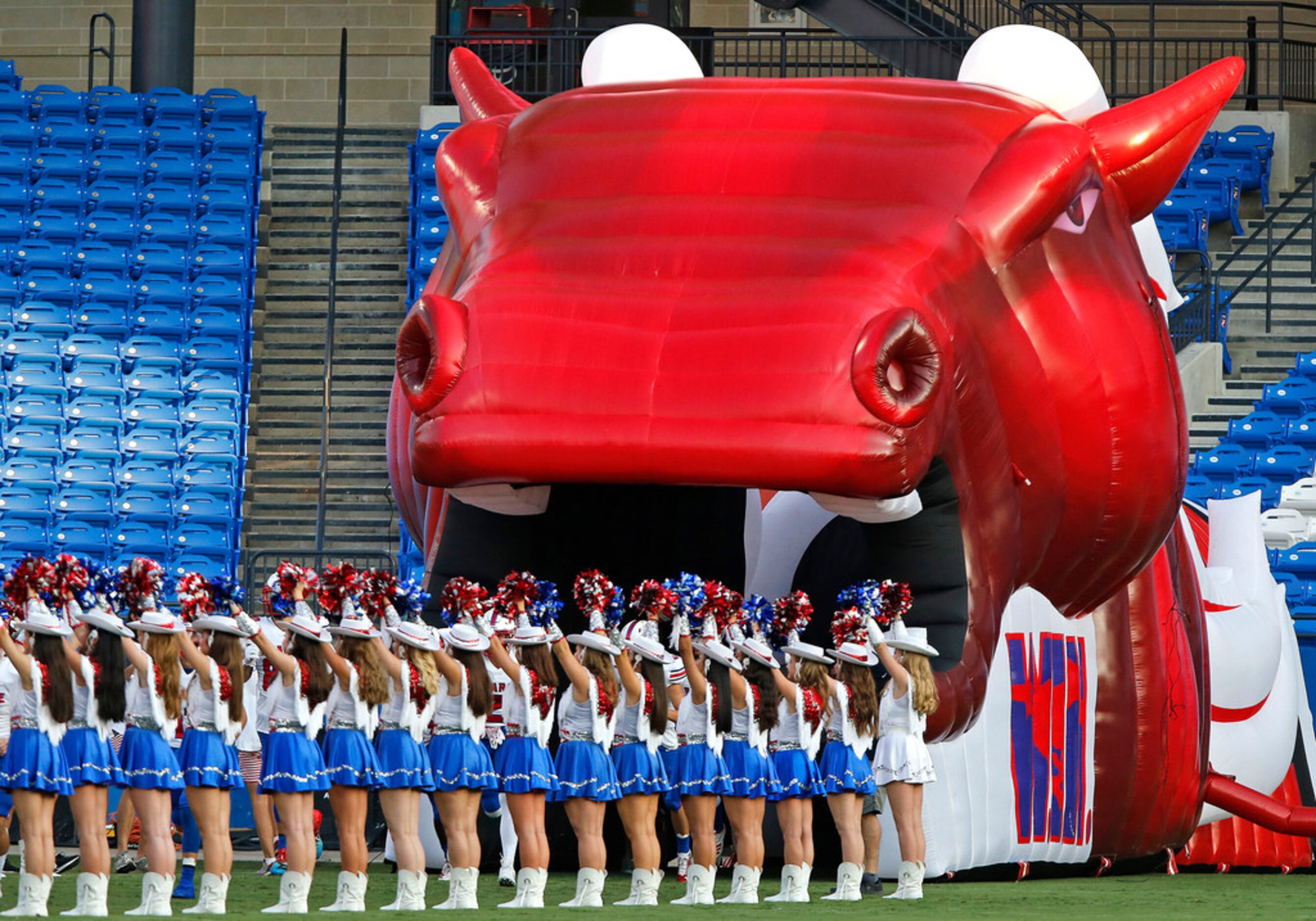 The Pearce High School Pacesetters drill team stands at attention while the football team...