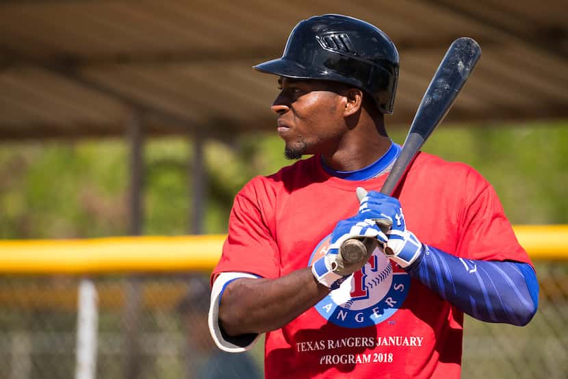 Cuban outfield Julio Pablo Martinez hits in a tryout game during a camp at the Rangers'...
