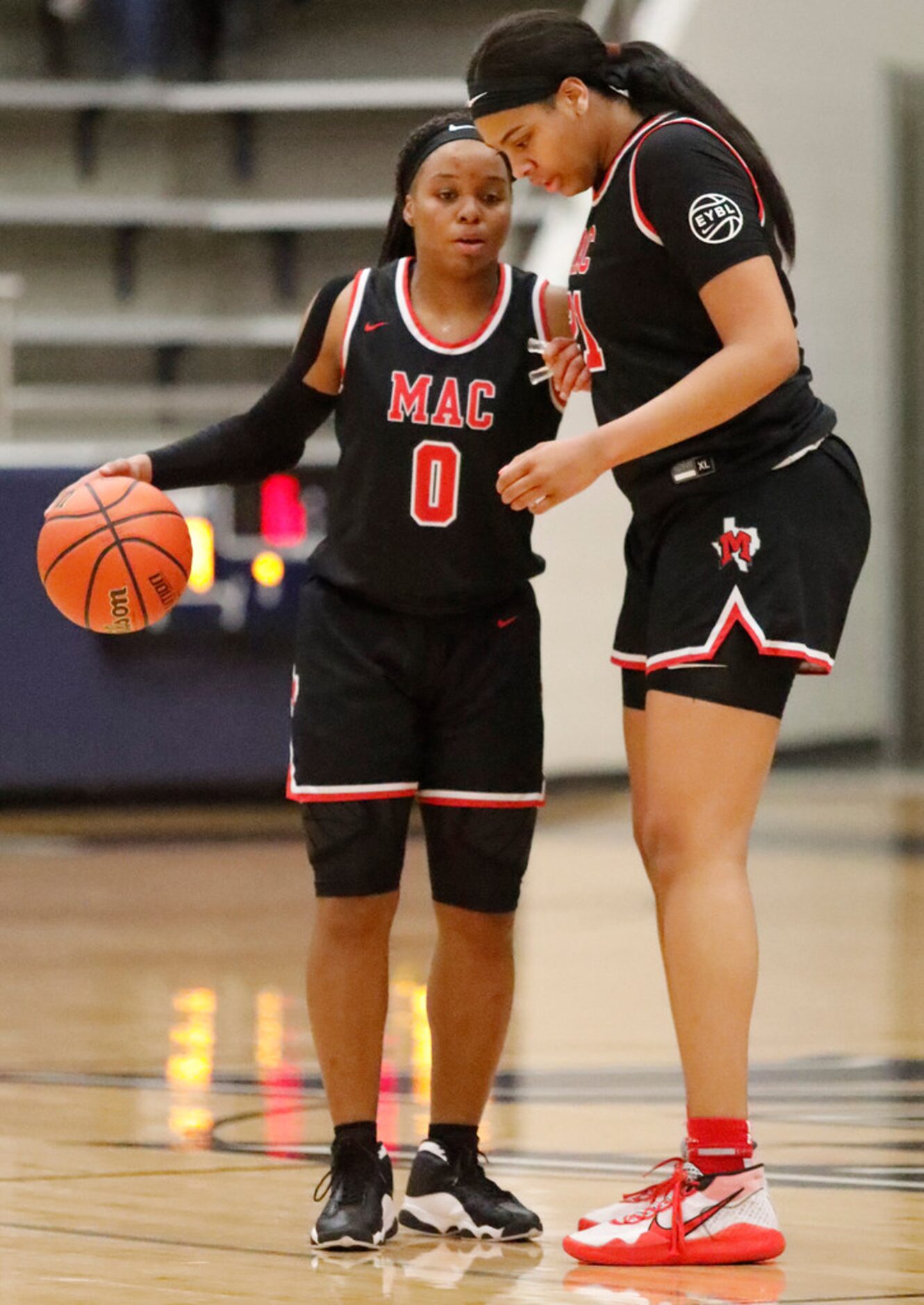 Irving MacArthur High School guard Sarah Andrews (0) gives instruction to Irving MacArthur...