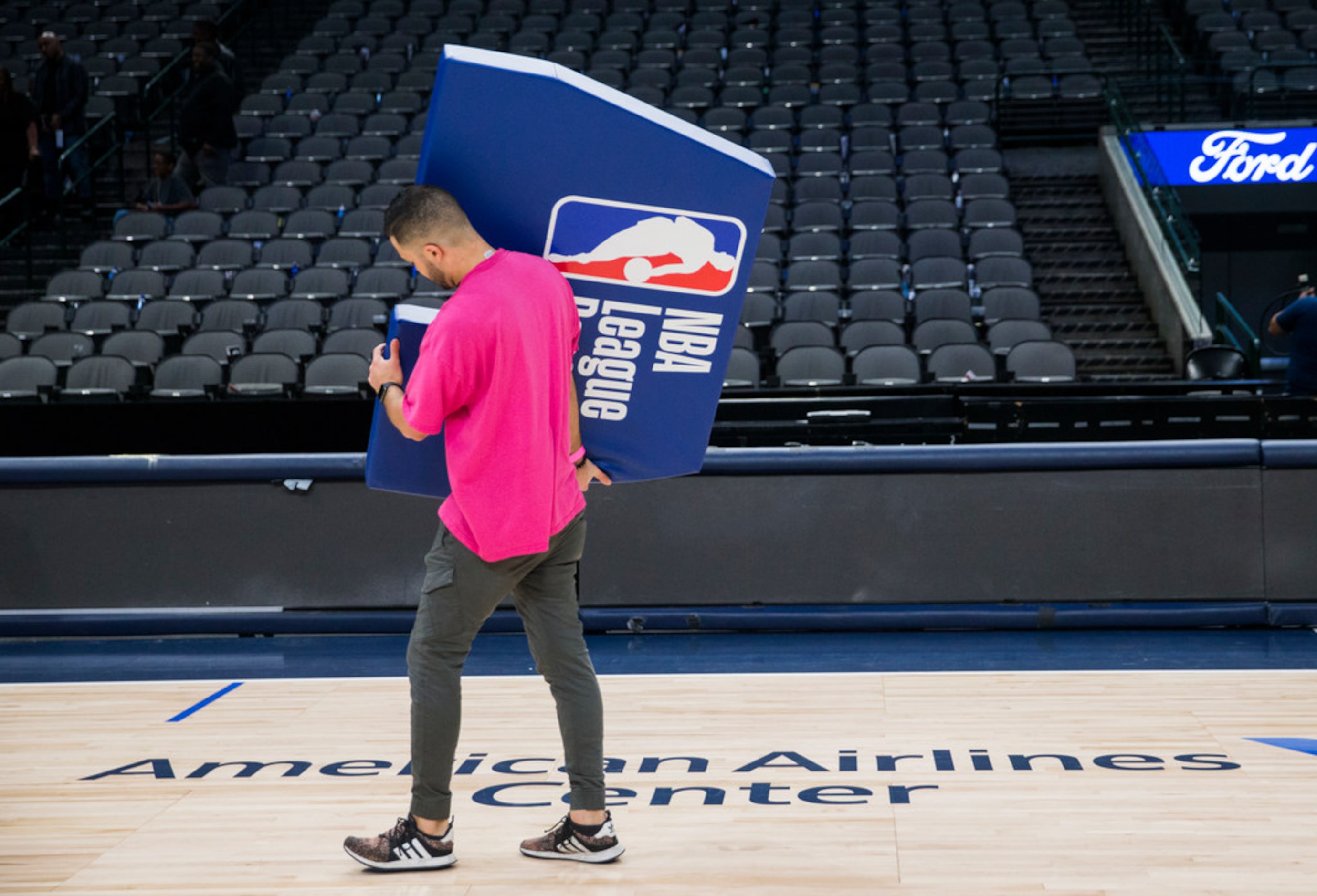 Crews break down the court after the Dallas Mavericks beat the Denver Nuggets 113-97 on...