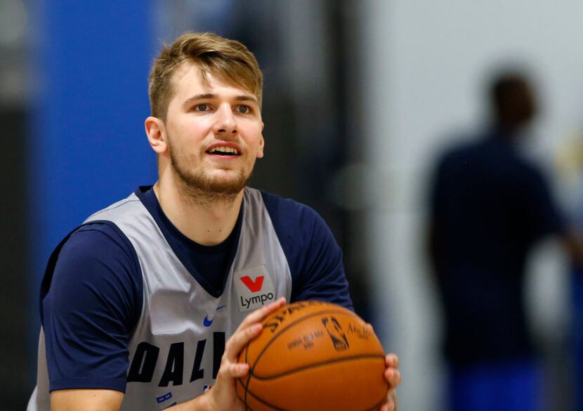 Dallas Mavericks Luka Doncic (77) shoots a shot from half court after practice after...