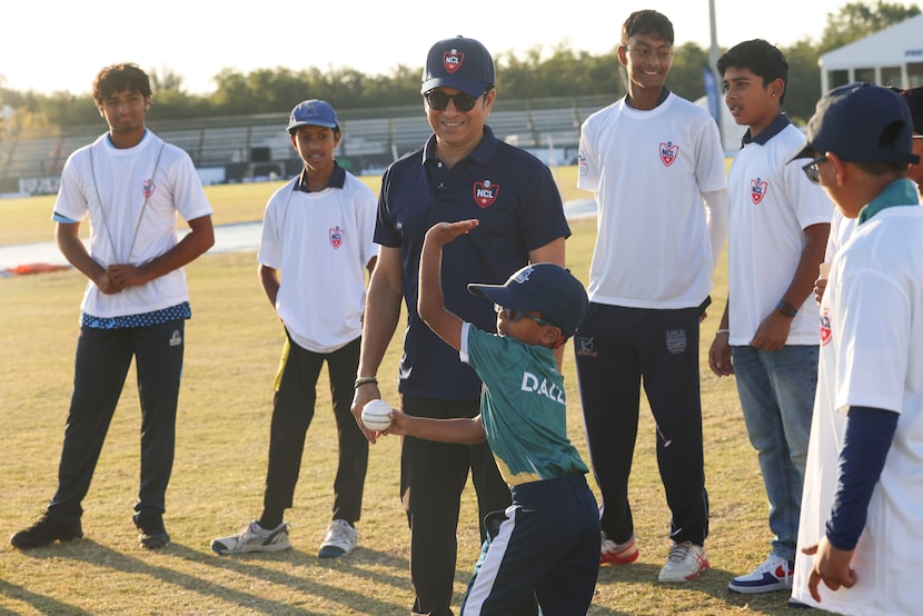 Cricket legend Sachin Tendulkar, watches as young athletes train during a session, on...