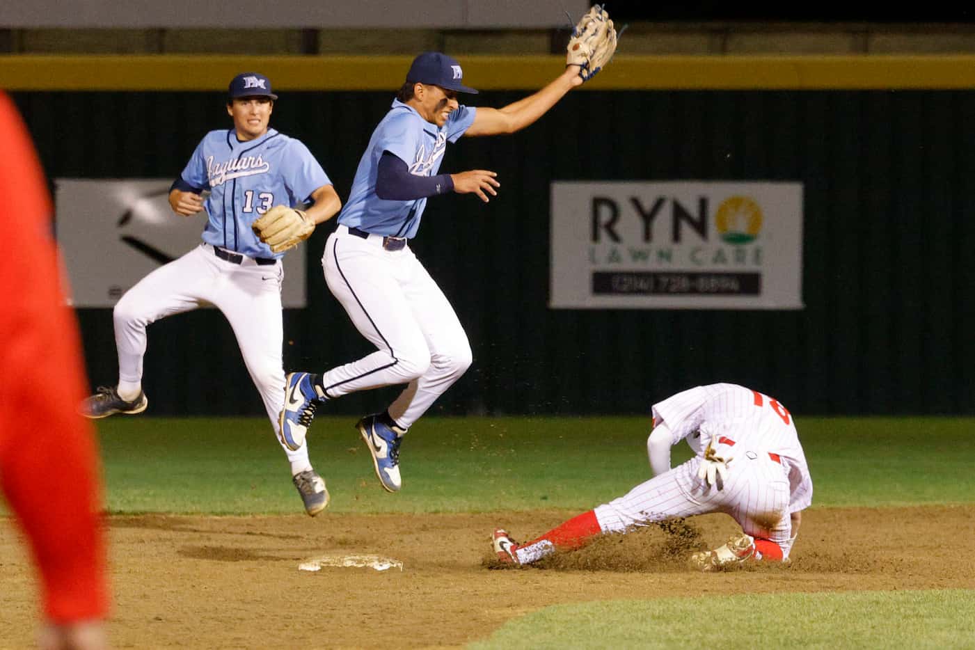 Marcus’ Cayden Fisk slides safely into second base before a tag by Flower Mound’s Adrian...