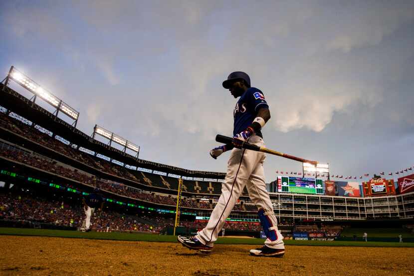 Texas Rangers shortstop Jurickson Profar (19) walks on the field to warm up before batting...