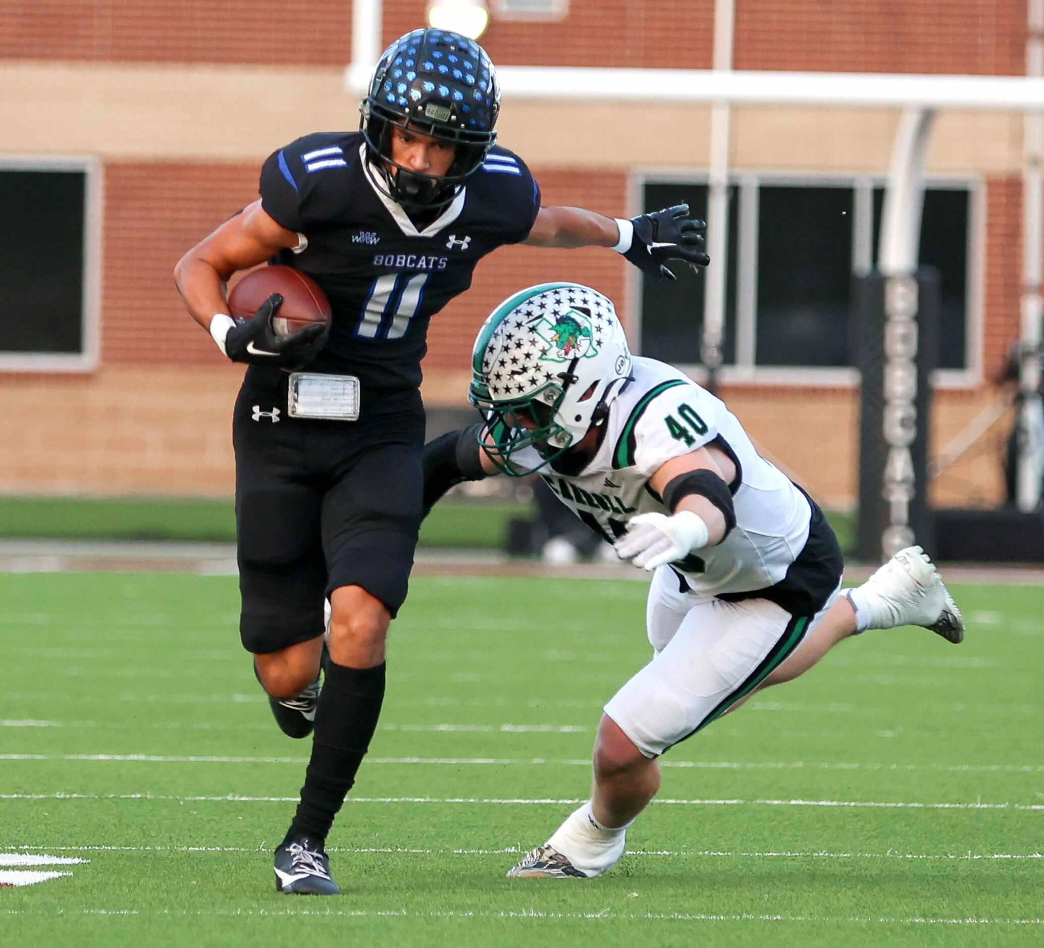 Byron Nelson wide receiver Leo Almanza (11) tries to avoid Southlake Carroll defensive...