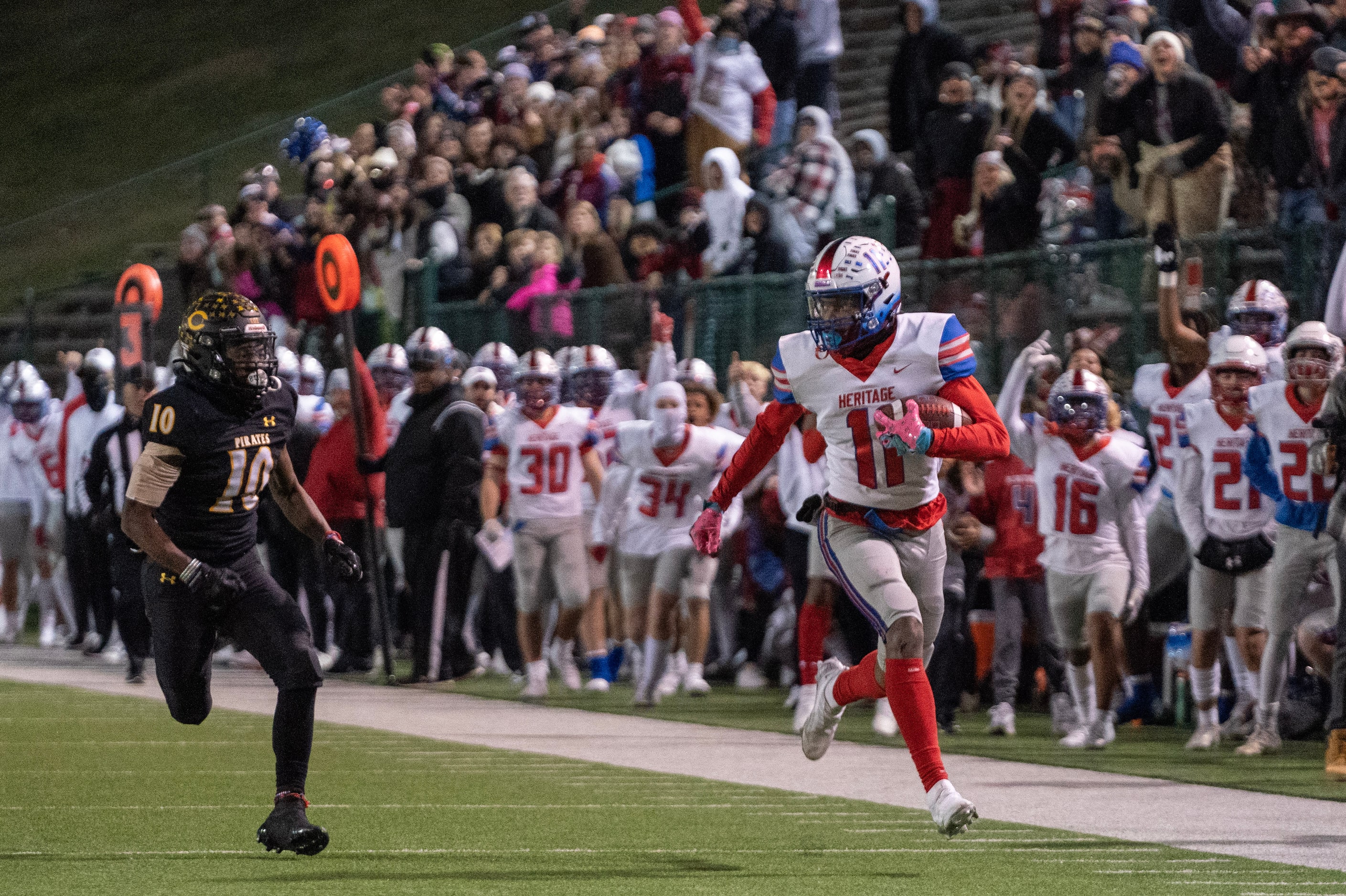 Midlothian Heritage senior wide receiver Xavier Moten (11) runs away from Crandall senior...