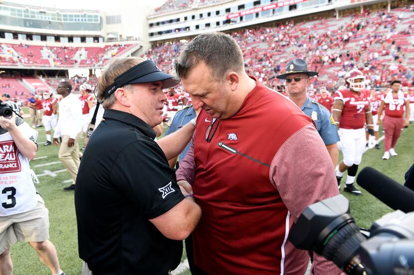 TCU coach Gary Patterson, left, shakes hands with Arkansas coach Bret Bielema after an NCAA...