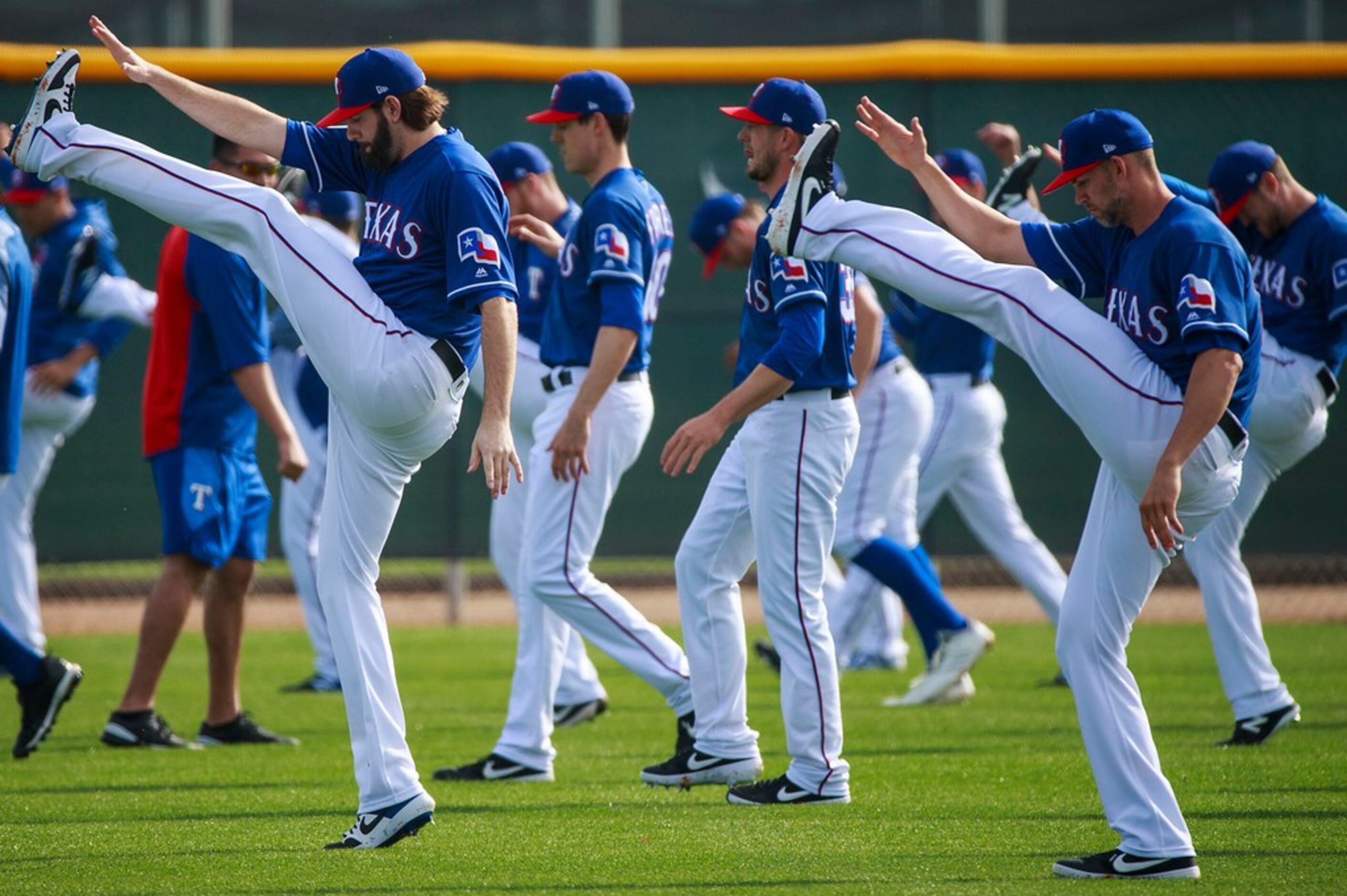 Texas Rangers pitchers Jason Hammel (left) and Mike Minor stretch during a spring training...