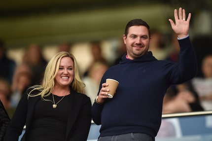 Chris Kirchner (right) waved to the crowd during an April 2022 championship soccer match...