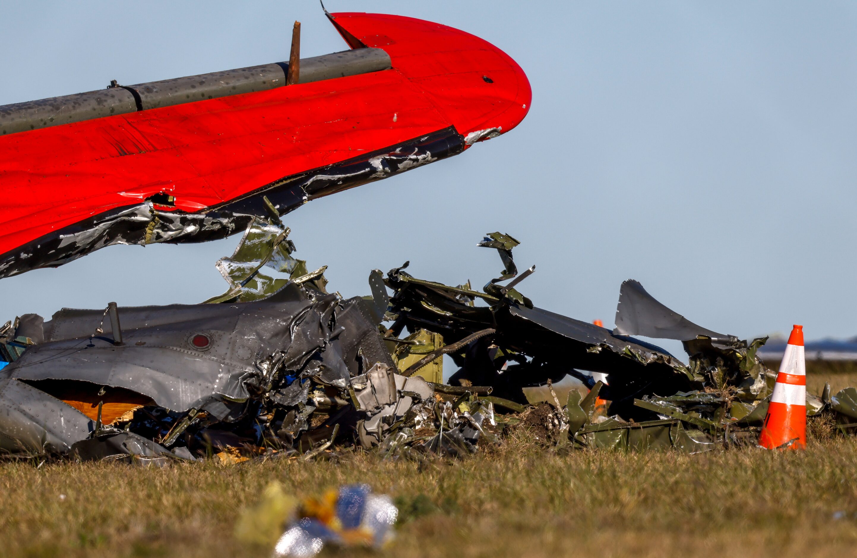 Debris lays scattered around a damaged plane at the Dallas Executive Airport on Sunday, Nov....