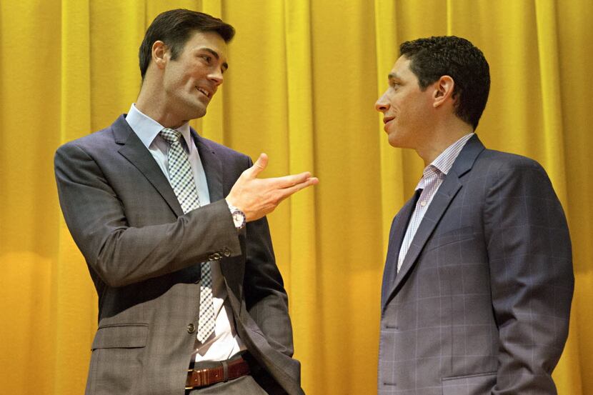 Texas Rangers pitcher Cole Hamels (left) talks with general manager Jon Daniels following a...