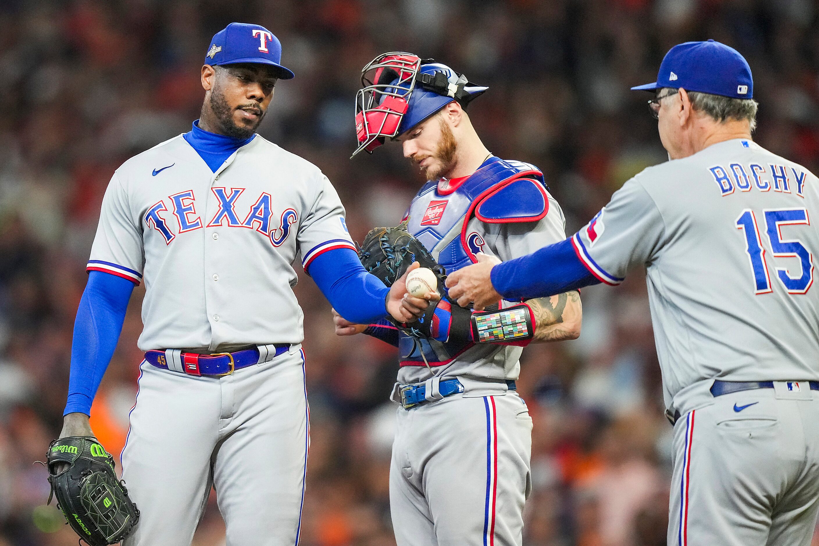 Texas Rangers relief pitcher Aroldis Chapman hands the ball to manager Bruce Bochy as he...