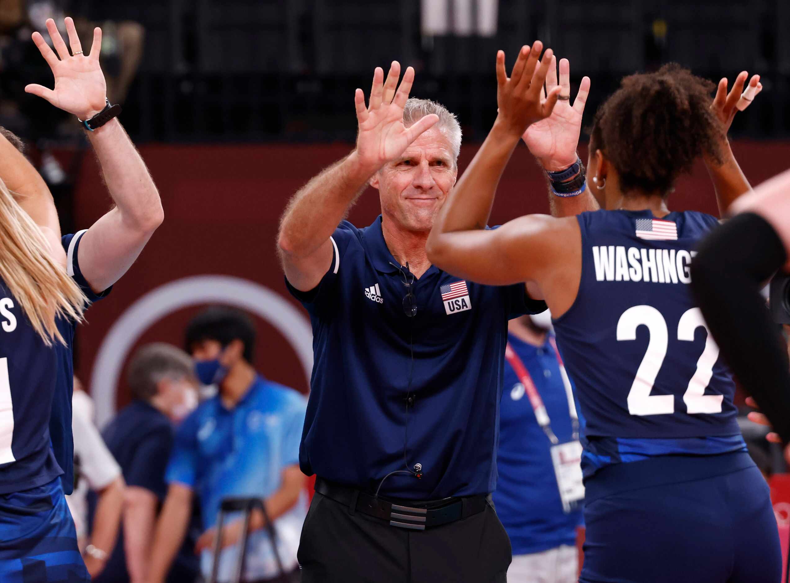 USA’s Haleighh Washington (22) slaps hands with head coach Karch Kiraly in celebration after...