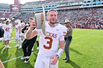 Texas quarterback Quinn Ewers (3) celebrates with his team after defeating Arkansas 20-10 in...