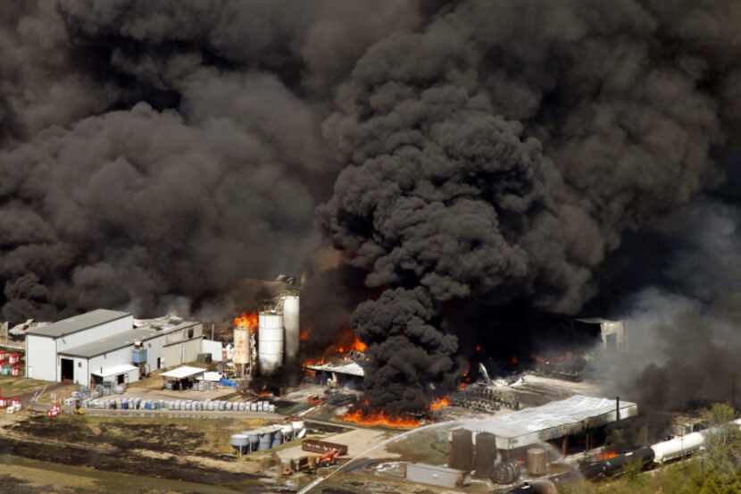 Giant plumes of black smoke rise from the Magnablend chemical processing plant in Waxahachie...