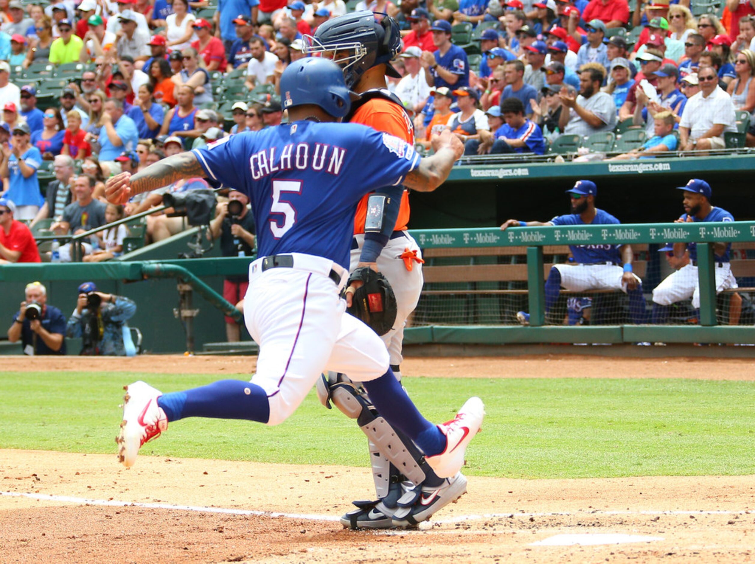 ARLINGTON, TX - JULY 14: Willie Calhoun #5 of the Texas Rangers scores in the first inning...