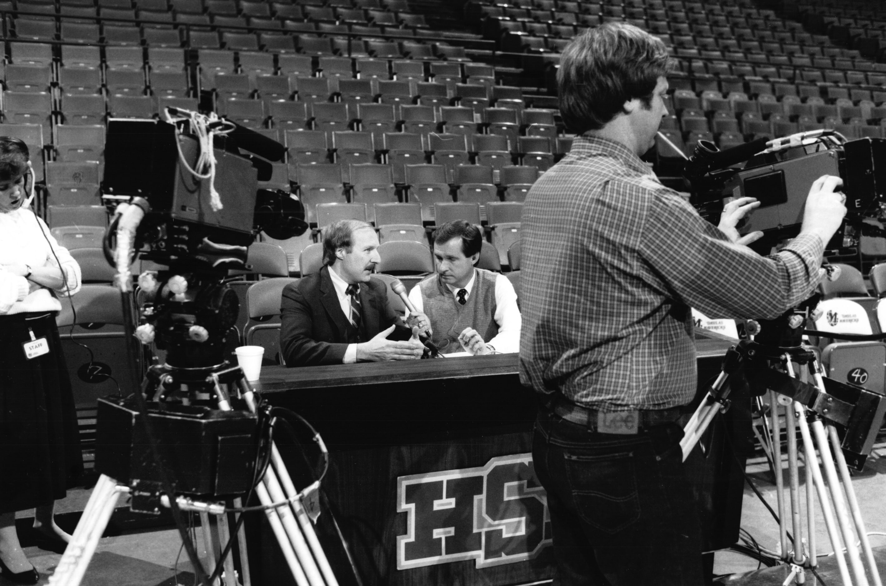 Radio personality Norm Hitzges, seated left, is interviewed prior to a Dallas Mavericks...