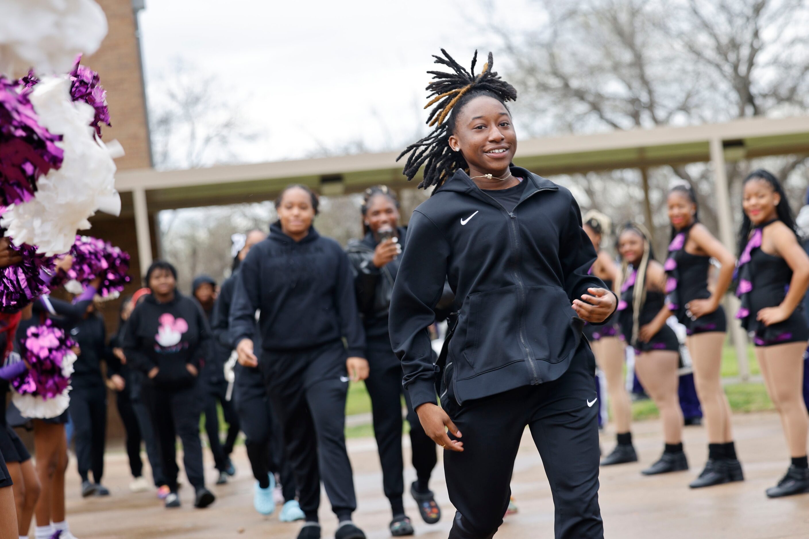 Lincoln High School basketball player Kayla Crowder and her teammates walk to a bus after a...