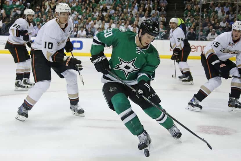 Dallas Stars center Cody Eakin (20) tries to navigate between four Anaheim defenders in the...