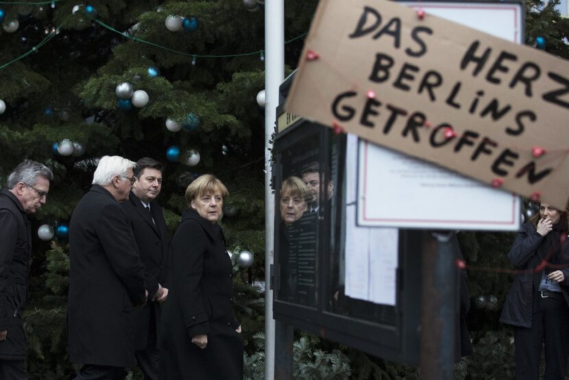 Angela Merkel, Germany's chancellor, center, Thomas de Maiziere, Germany's interior...