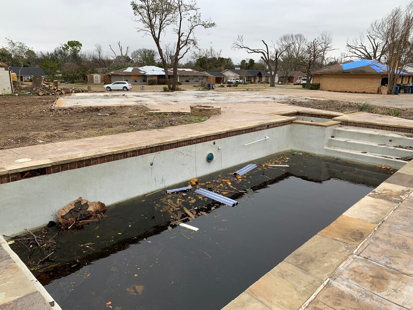 A foundation and swimming pool are all that remain of this house on Martha Lane after a...