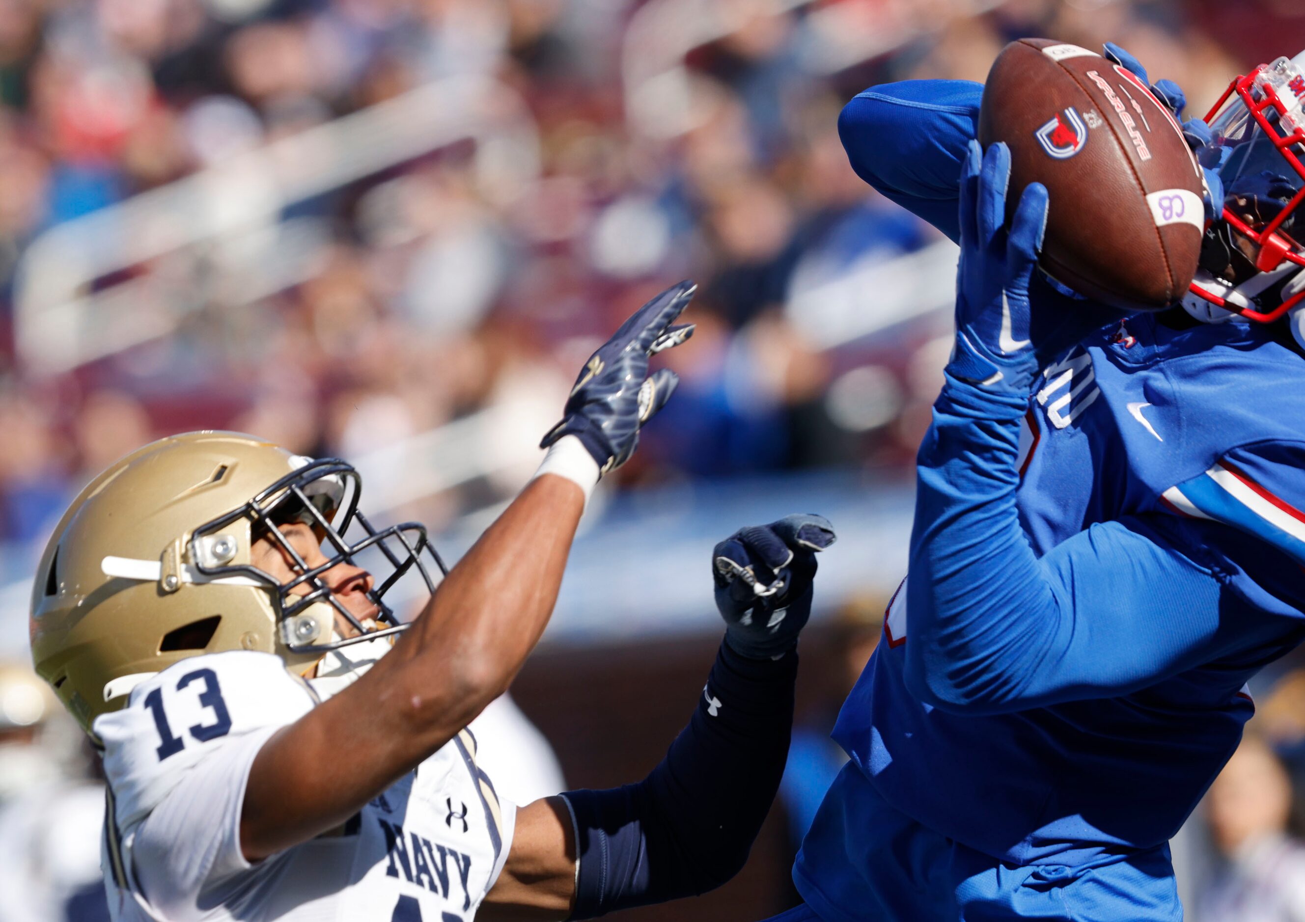 SMU wide receiver Jordan Hudson (8) catches a pass under pressure from Navy cornerback...