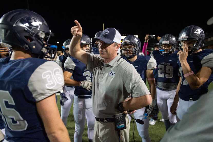 Flower Mound head coach Brian Basil instructs his team before the opening kickoff of a high...