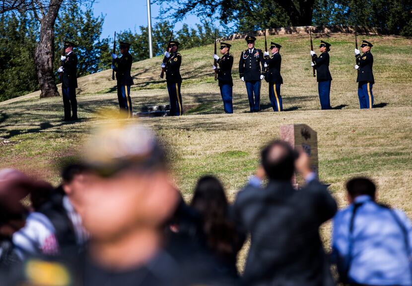 A 21-gun salute pays tribute to Richard Overton during a graveside service the Texas State...