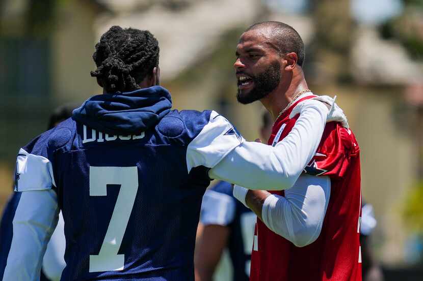 Dallas Cowboys quarterback Dak Prescott (4) talks with cornerback Trevon Diggs (7) during...