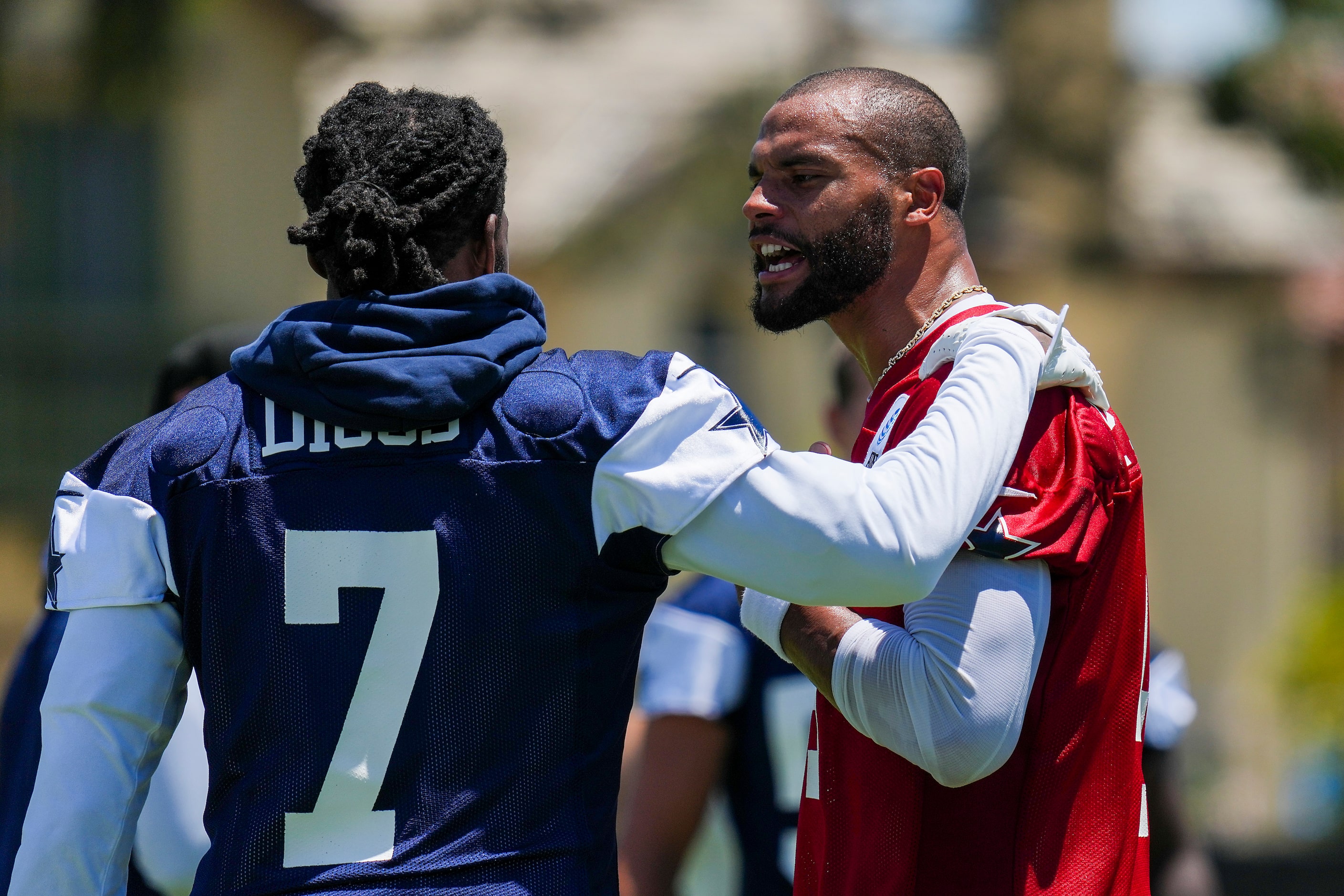 Dallas Cowboys quarterback Dak Prescott (4) talks with cornerback Trevon Diggs (7) during...