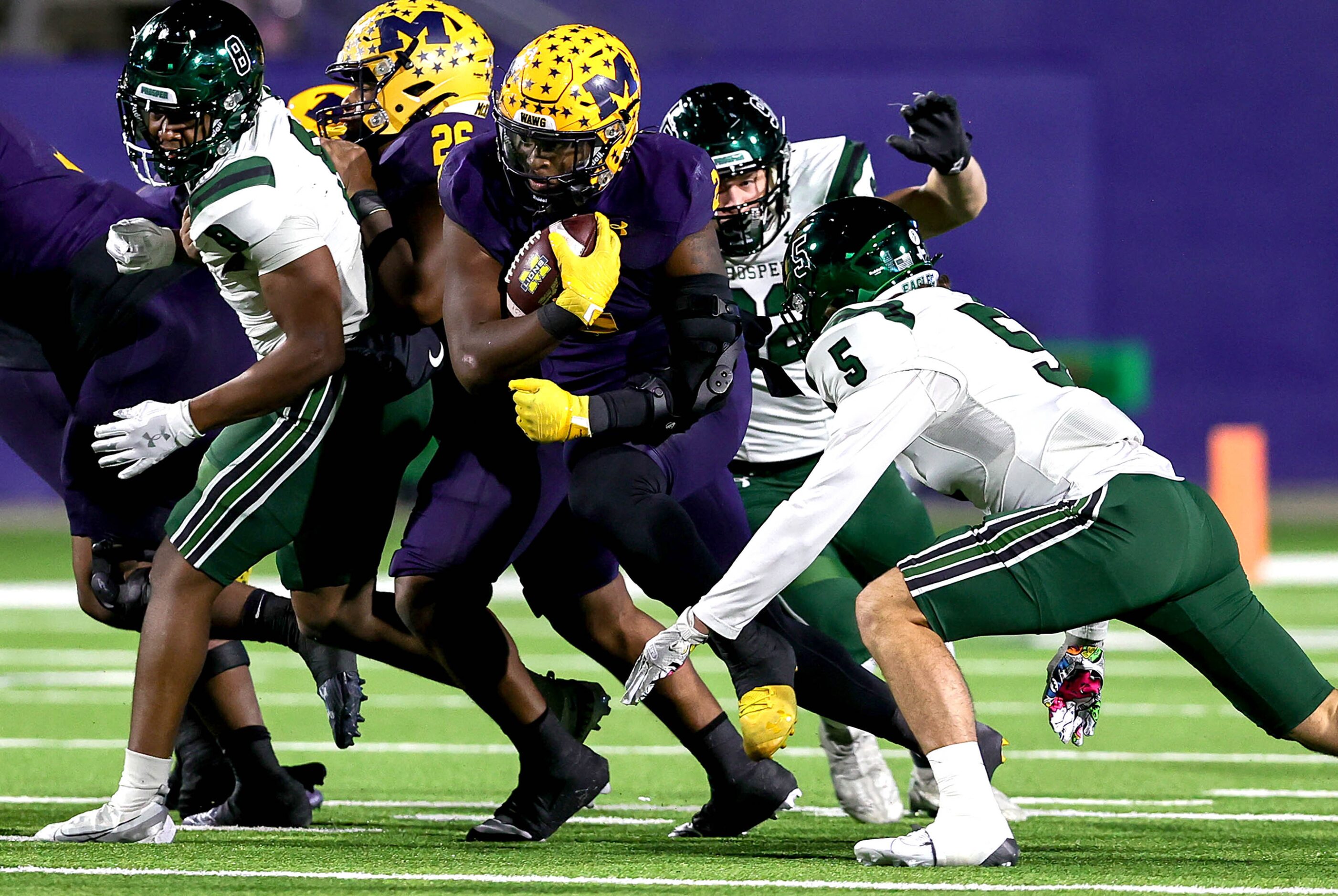 McKinney running back Bryan Jackson (2) tries to avoid Prosper linebacker Jonah McClendon...