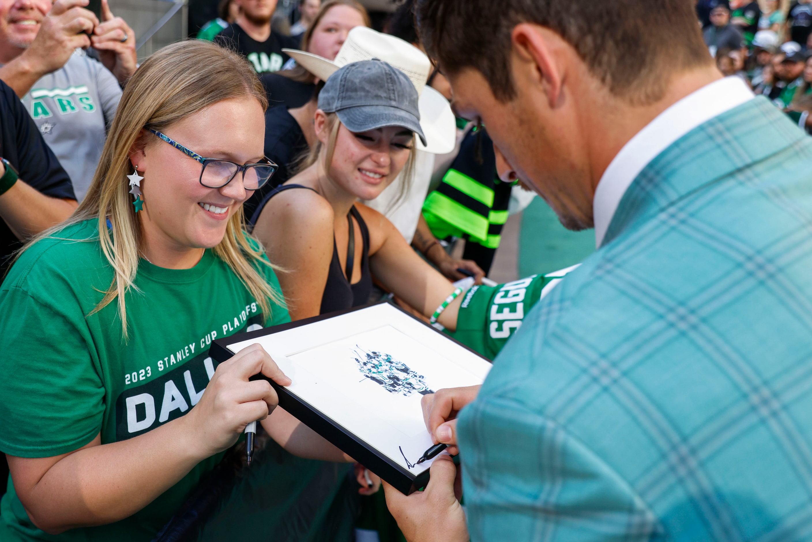 Dallas Stars left wing Mason Marchment gives autograph to a fan during the team’s home...