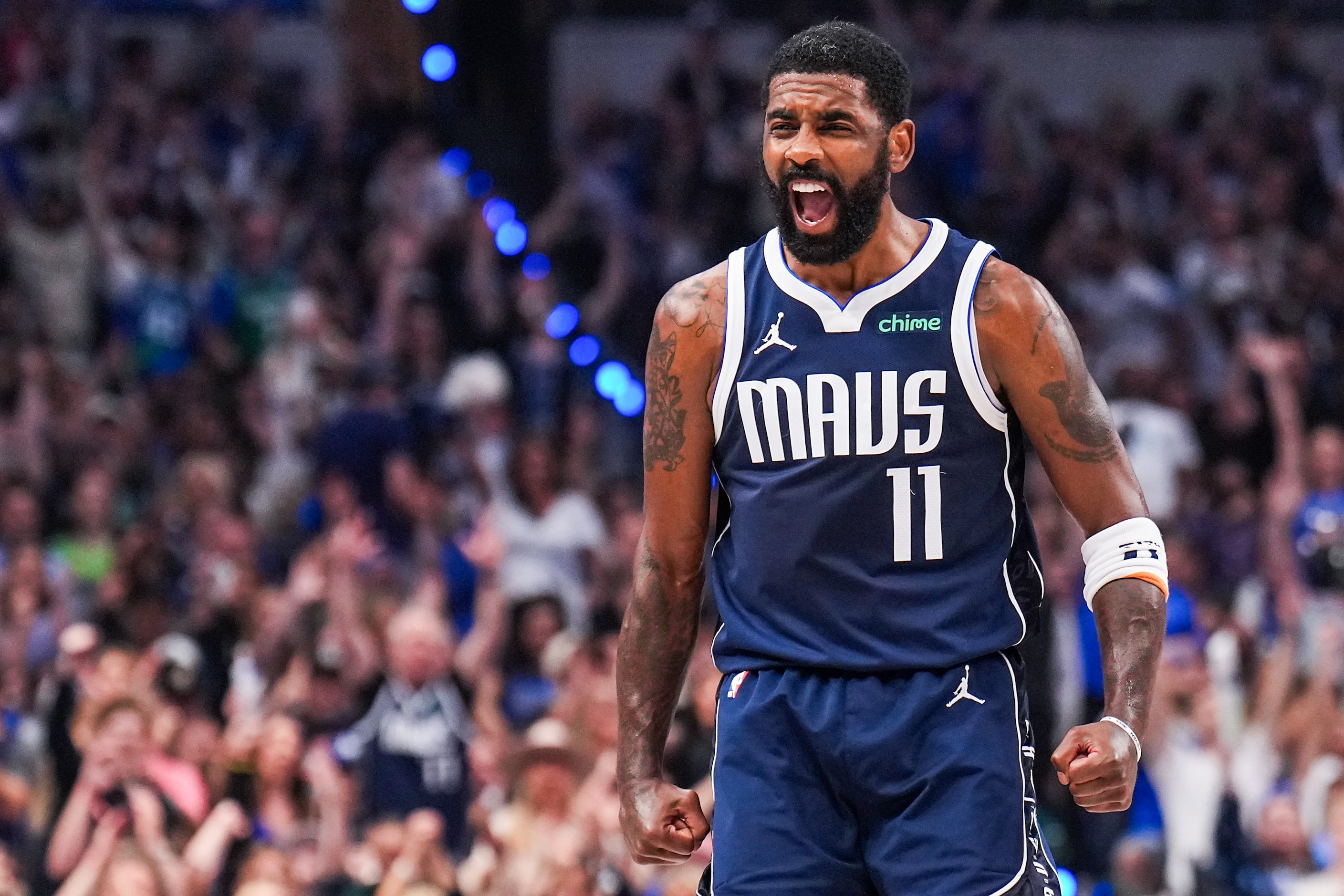 Dallas Mavericks guard Kyrie Irving (11) celebrates after a 3-pointer by Dante Exum during...