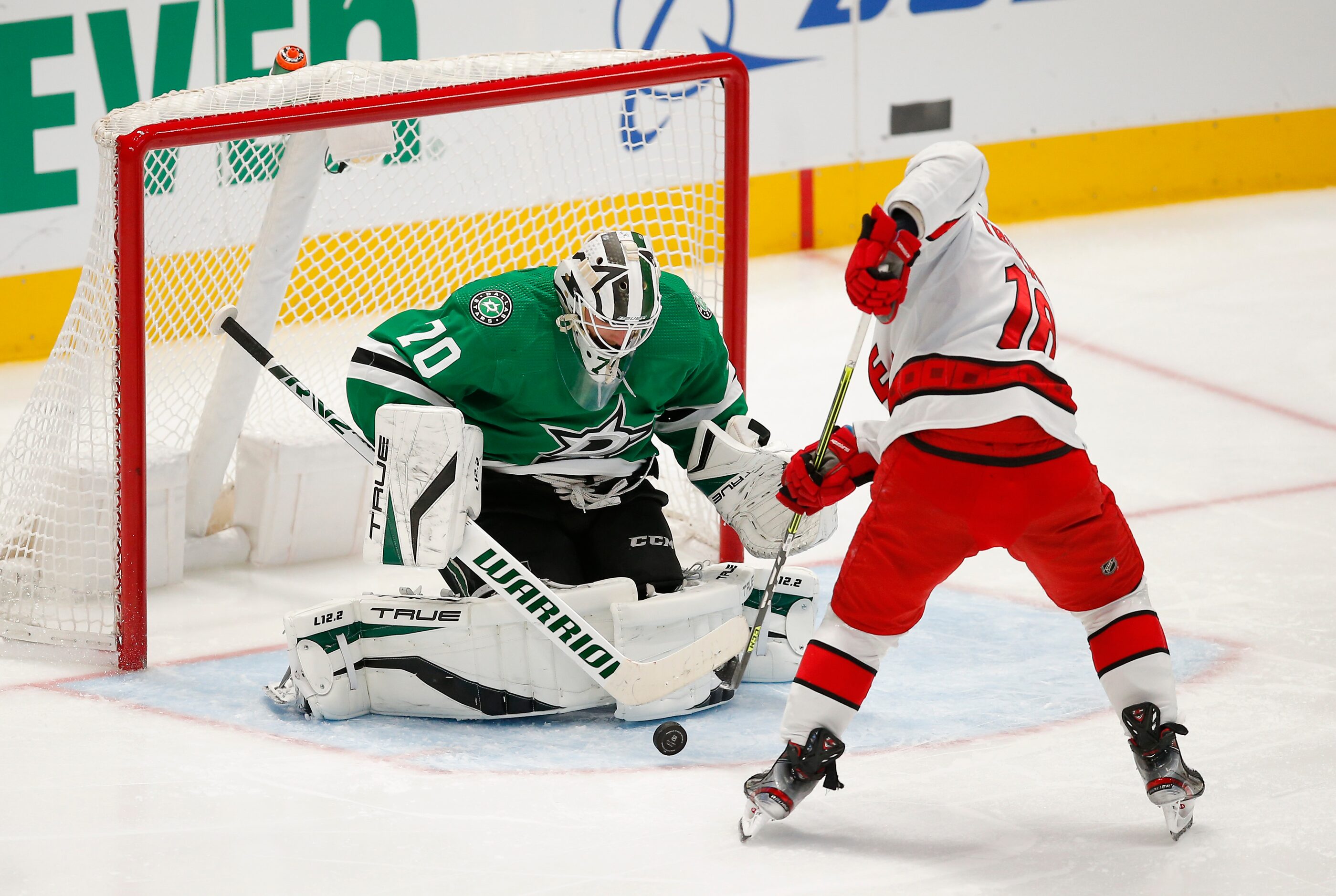 Carolina Hurricanes forward Derek Stepan (18) attempts to play a rebound off of Dallas Stars...