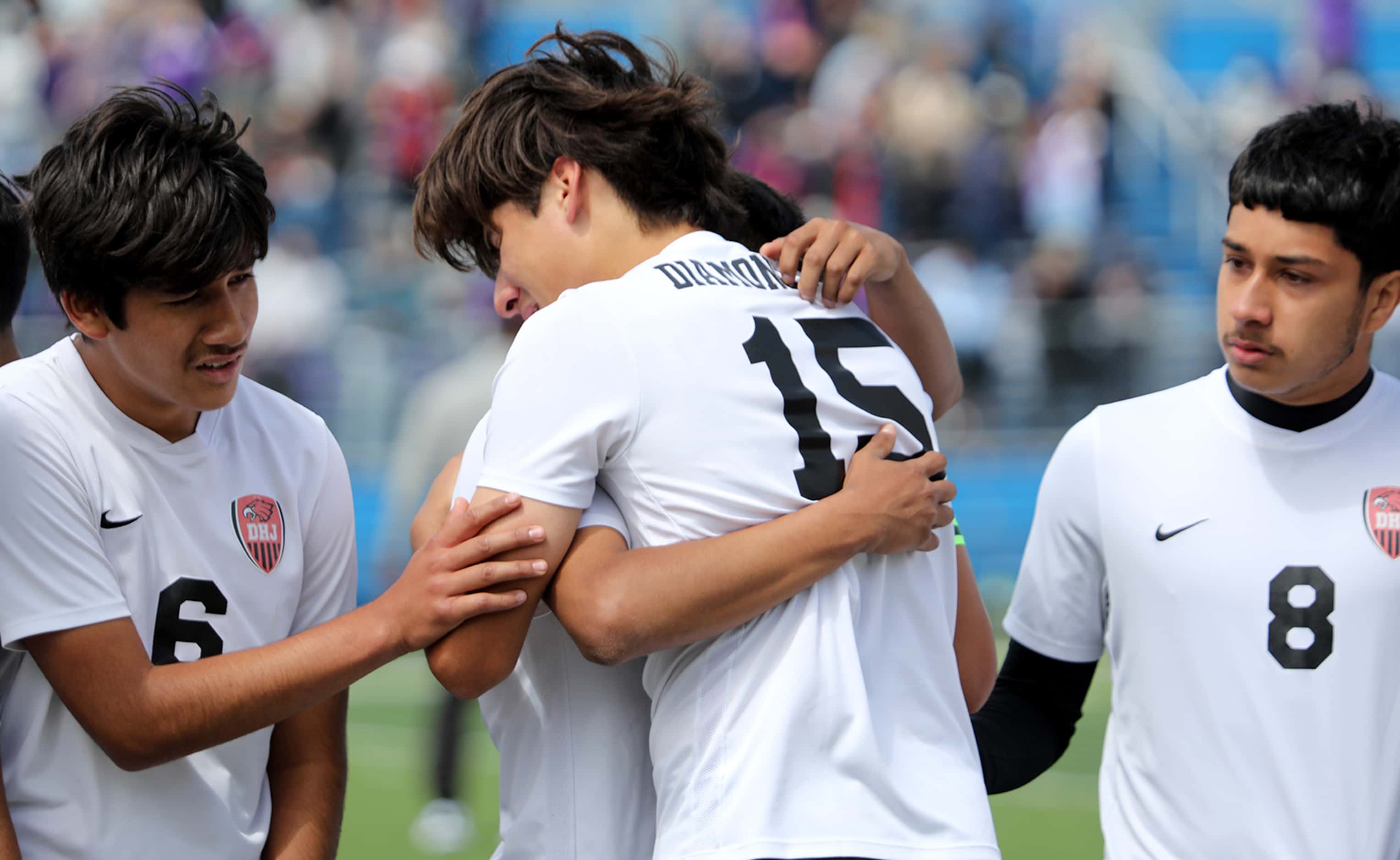 Fort Worth Diamond Hill-Jarvis players hug after their UIL 4A boys State championship soccer...