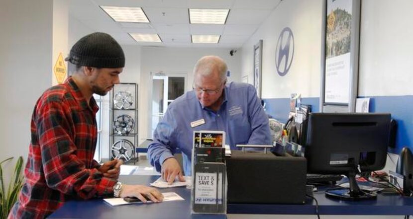 
Jared Freeman (left) gets help from Keith Archer of the Bob Stallings Hyundai service...