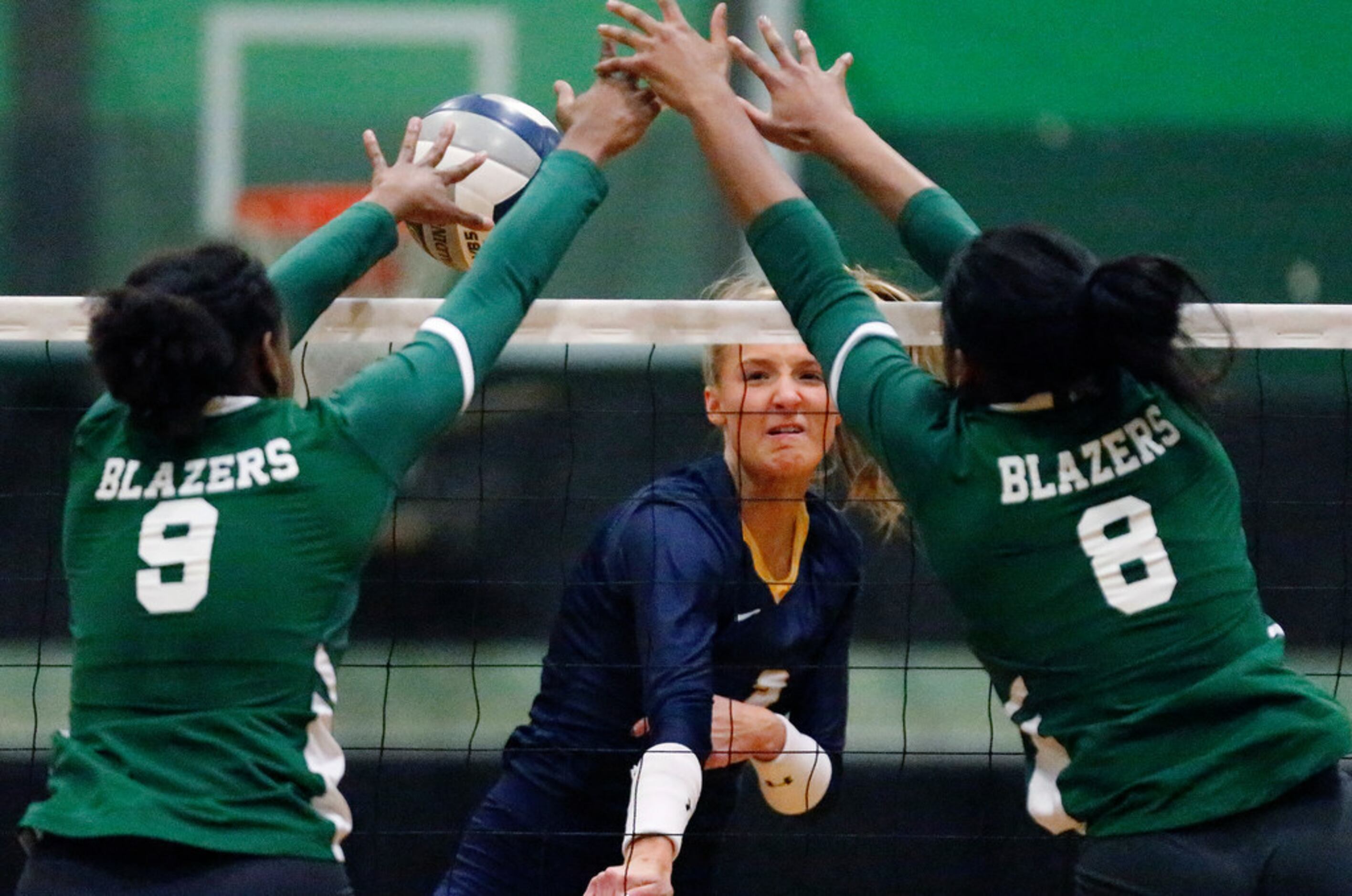 Highland Park High School outside hitter Kate Nugent (2) has a hit blocked by Lebanon Trail...