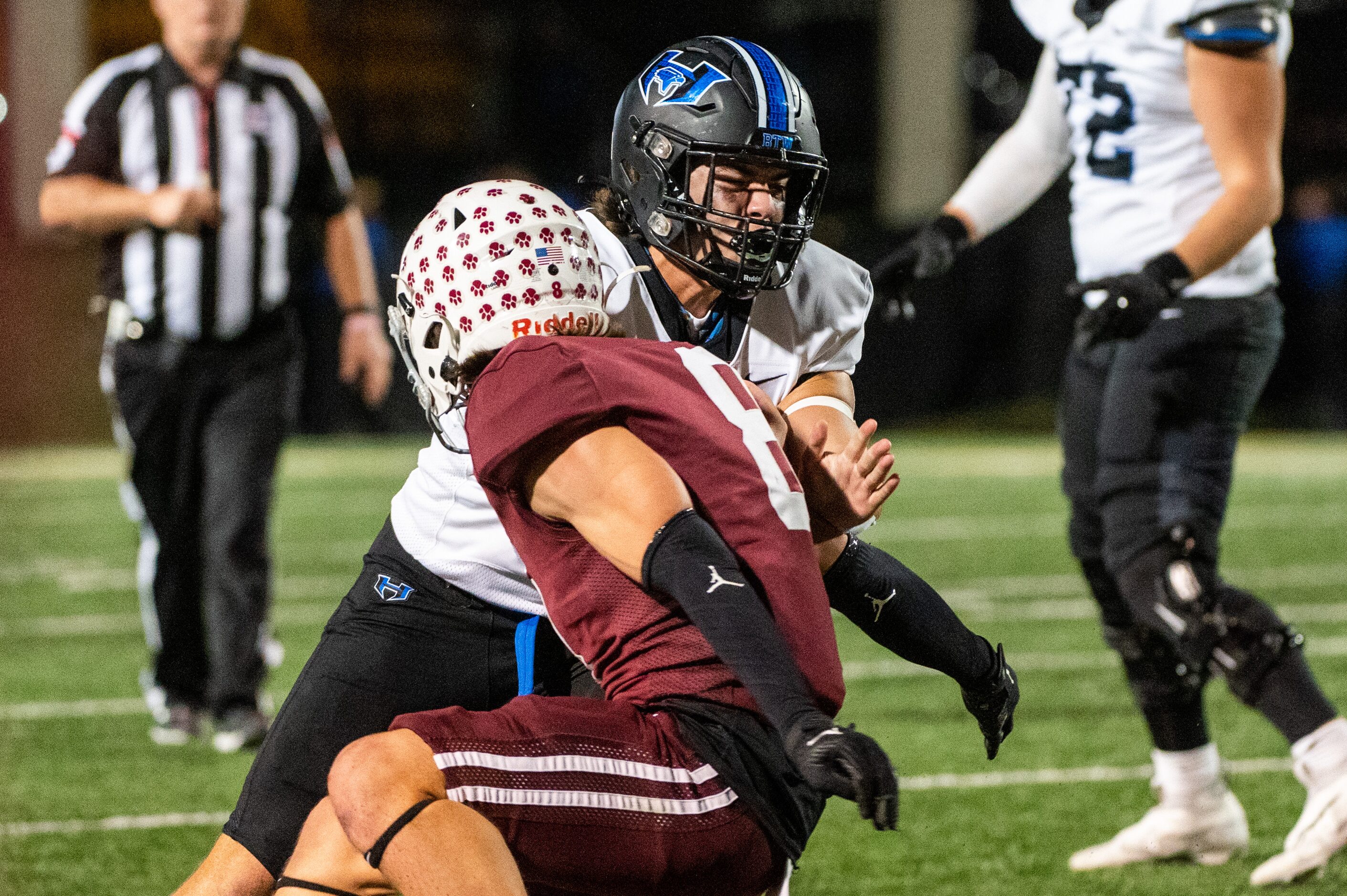 Hebron's Antonio Dennis (21) looks for running room around Plano's Jeffrey Sekula (8) in the...