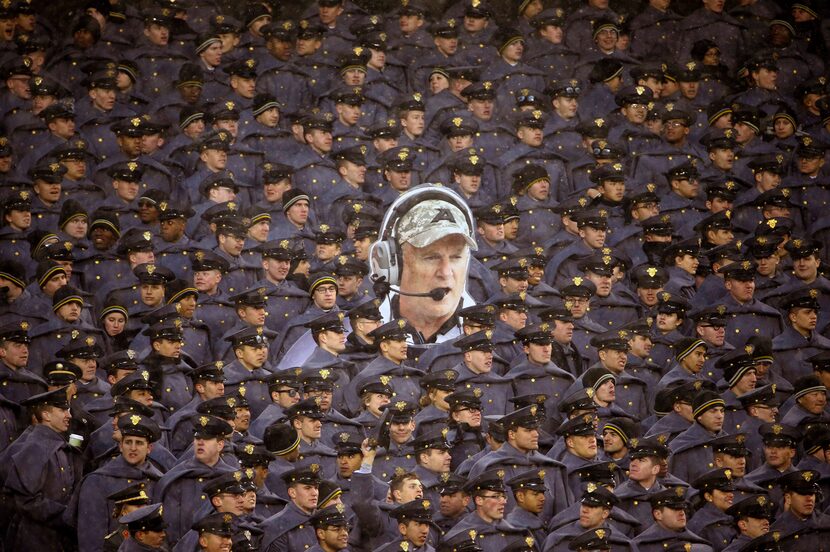  Army cadets hold a large photo of Army head coach Rich Ellerson during an NCAA college...