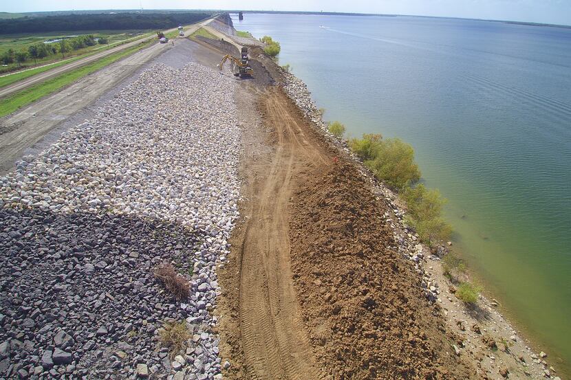 Repairs are almost complete on a 160-foot slide on the Lewisville Lake dam. Work should be...