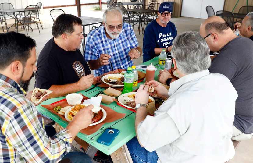 Texas BBQ Posse founding members Chris Wilkins (second from left) and Gary Jacobson (third...