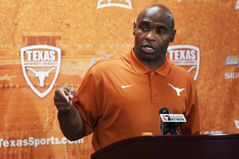 Texas football coach Charlie Strong speaks during a news conference at the NCAA college...