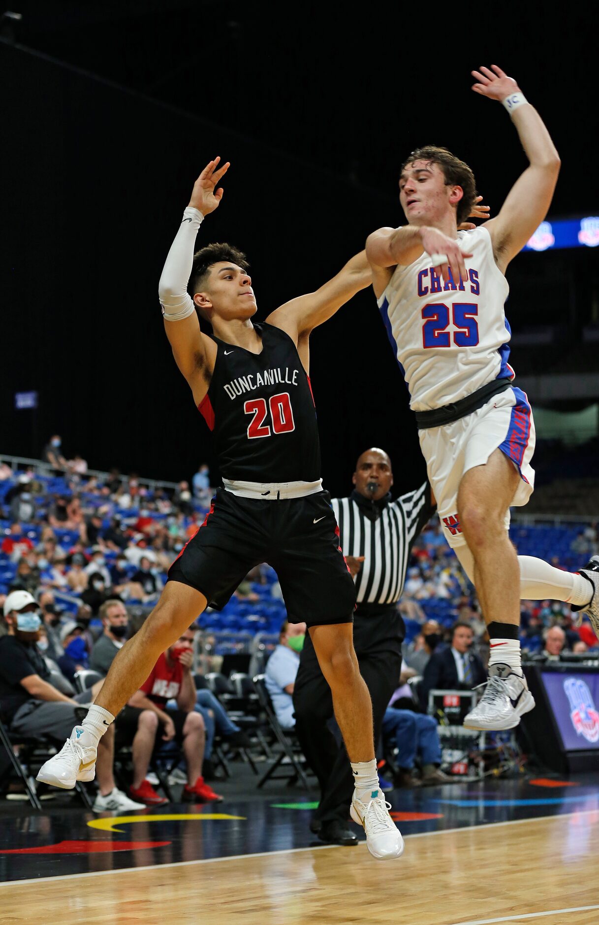 Duncanville Juan Reyna #20 makes a three despite pressure from Westlake Eain Mowat #25. UIL...