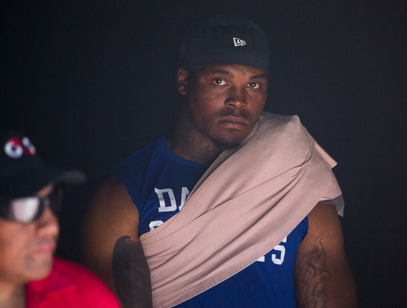 Dallas Cowboys linebacker Chris Covington (59) watches the game from the tunnel after...