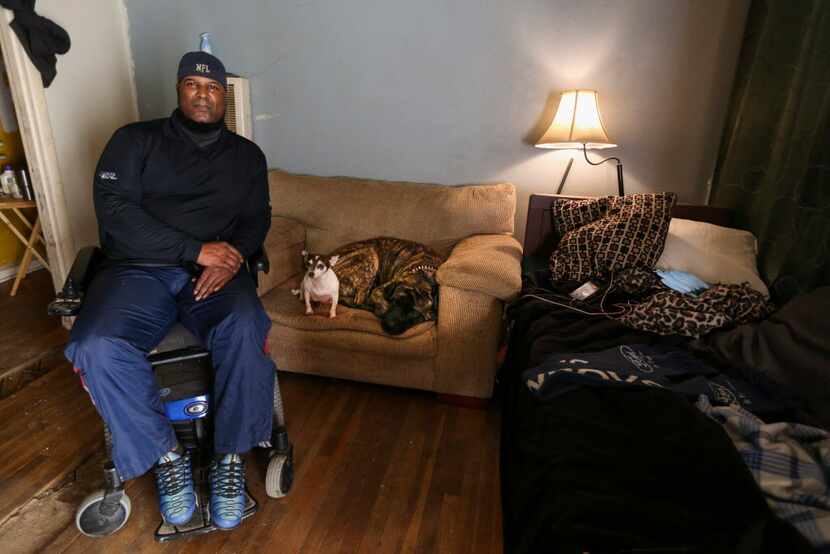 Mark Booker, alongside his dogs Butter (center) and Rick, at his Hamilton Park home Tuesday....