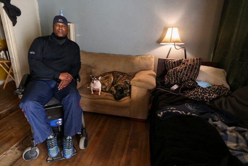 Mark Booker, alongside his dogs Butter (center) and Rick, at his Hamilton Park home Tuesday....