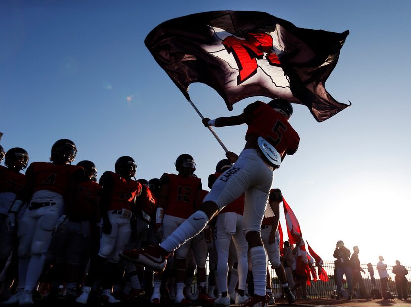 TXHSFB Irving MacArthur senior quarterback Brion Lopez (5) rallies his teammates before the...