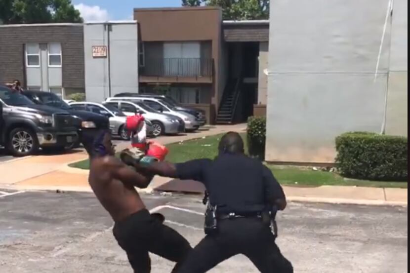 Officer Winston Bowen spars with a teenager who challenged him at a neighborhood barbecue.